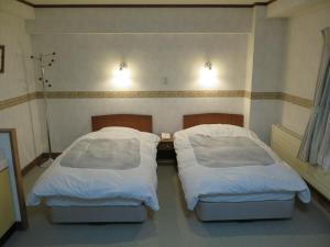 A bed or beds in a room at New Yokote