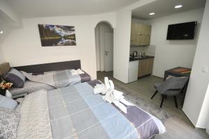 a hotel room with two beds and a kitchen at Kate Apartments in Ohrid