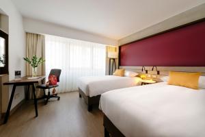 Ένα ή περισσότερα κρεβάτια σε δωμάτιο στο Mercure Ariosto Lima