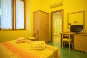sypialnia z łóżkiem, biurkiem i telewizorem w obiekcie B&B al Centro Storico w mieście Napoli