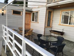 a patio with tables and chairs on a house at Casa frente a la playa in Valdivia