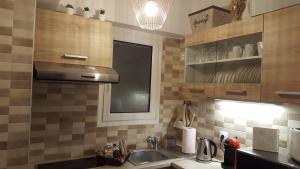 a kitchen with a sink and a counter top at Zoe's Studio in Athens