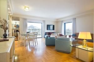 a living room with a couch and a table at Alexander's Penthouse in Athens