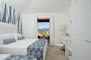 Amareclub Janna e Sole Resort tesisinde bir odada yatak veya yataklar