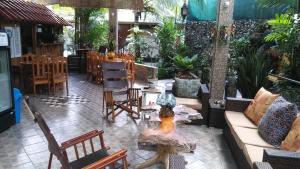 a living room filled with furniture and a patio at Coyaba Tropical Elegant Adult Guesthouse in Manuel Antonio