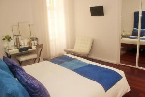
a bedroom with a bed and a desk at Tavira House in Tavira
