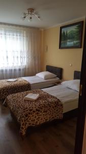 Postel nebo postele na pokoji v ubytování Zatishok Guest House