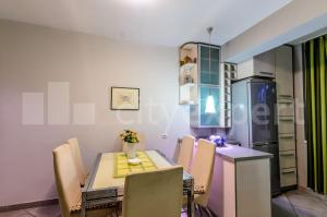 a dining room with a table and chairs at Apartment Hram in Belgrade
