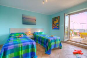 2 camas individuais num quarto com uma janela em Appartamento a pochi passi dal mare em Formia