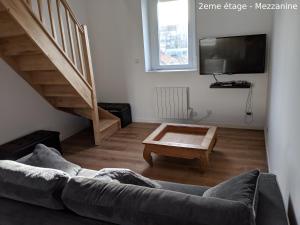 a living room with a couch and a coffee table at Appartements Boulonnais in Boulogne-sur-Mer