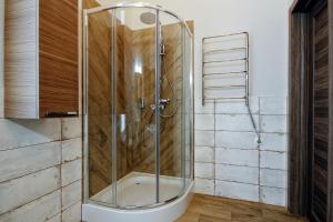 a shower with a glass door in a bathroom at D5 Apartments in Odesa +25 photos