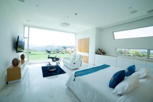 a bedroom with a large bed and a large window at Punta Diamante Premium Hotel in Bucaramanga +53 photos