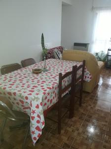 a dining room table with a red and white table cloth at Casa de Andrea in Esquel