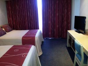 Voodi või voodid majutusasutuse Hotel Fleming toas