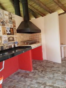 a kitchen with a brick stove in a room at Villa Suzana in Praia do Rosa