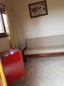 a room with a bench and a painting on the wall at Villa Suzana in Praia do Rosa