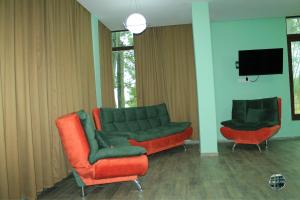 a living room with a couch and two chairs at Shekvetili Green House in Shekhvetili