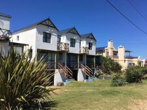 a large white house with a lot of windows at Balcones del Cabito in La Paloma