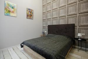 a bedroom with a bed and a wooden wall at D5 Apartments in Odesa
