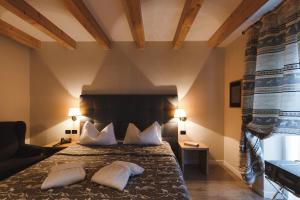 a hotel room with a bed with two pillows at Hotel Savoia dal 1924 in San Martino di Castrozza