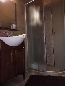a bathroom with a shower and a white sink at Archontiko Kirfis in Desfina in Dhesfína +31 photos