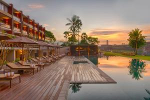 a hotel with a pool with chairs and a sunset at Le Grand Galle in Galle