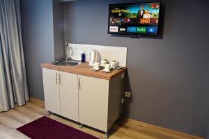 a bathroom with a sink and a tv on the wall at ARS Taxim Hotel in Istanbul