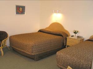 Postel nebo postele na pokoji v ubytování Coachman Motel