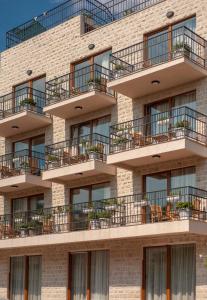 an apartment building with balconies on it at Hotel Twelve by Aycon in Budva