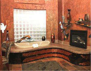 a living room with a fireplace and a tub at Adobe Grand Villas in Sedona
