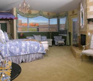 a bedroom with a bed and a couch and a fireplace at Adobe Grand Villas in Sedona