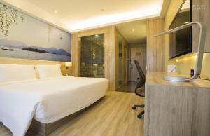 Krevet ili kreveti u jedinici u objektu Atour Hotel Hangzhou Xixi Zijingang