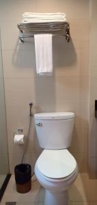 a bathroom with a white toilet and some towels at Tropicana Suites in Manila