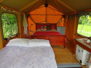 a bedroom with a bed in a tent at Omarama Oasis - Permaculture Glamping in Pohara