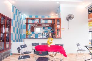 a dining room with a red table and chairs at Anna Nguyễn Bungalow in Phú Quốc