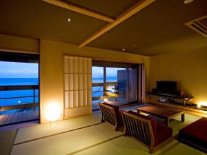 a living room with a view of the ocean at Amahara in Sumoto