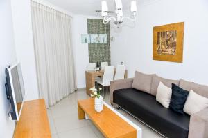 a living room with a couch and a table at Tiberias Holiday Apartment in Tiberias