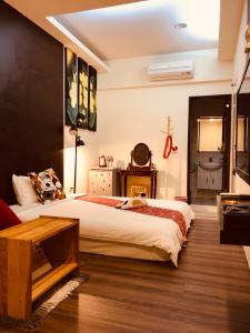 a bedroom with a large bed and a table at Enjoy Kenting in Kenting