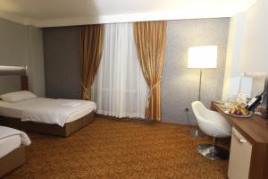 A bed or beds in a room at Suhan Cappadocia Hotel & Spa