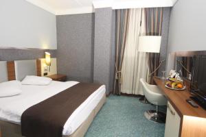 A bed or beds in a room at Suhan Cappadocia Hotel & Spa