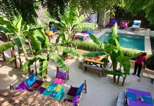 
a patio area with tables, chairs and umbrellas at Zanzistar Lodge in Jambiani
