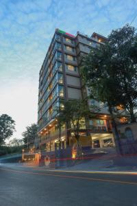 a tall building on the side of a street at Hotel Rose Hill in Yangon
