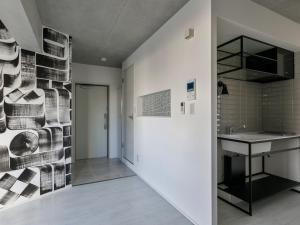 a bathroom with a sink and a wall at AOCA KAMINOGE 302 in Tokyo