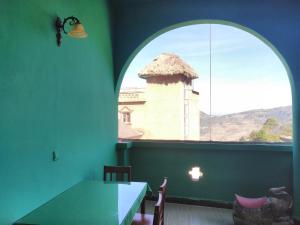 a room with a table and a window with a tower at Yuanyang Flower and Horse Inn in Yuanyang
