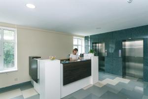 a woman standing at a counter in a bathroom at BeRest Plus in Kyiv