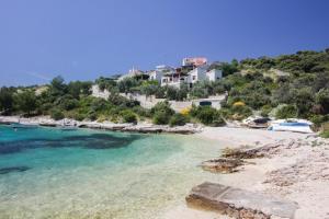 a view of a beach with boats in the water at Apartments Darinka in Sevid