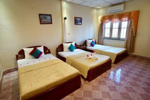 Postel nebo postele na pokoji v ubytování Royal Hotel