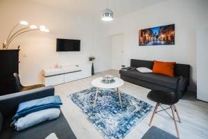 a living room with a couch and a table at Kavon Apartments in Ljubljana