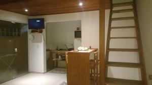 a kitchen with a staircase and a kitchen with a refrigerator at Pousada Ilha do Campeche in Florianópolis