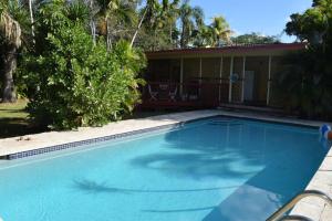 a swimming pool in front of a house at Home in the Heart of Miami in Miami